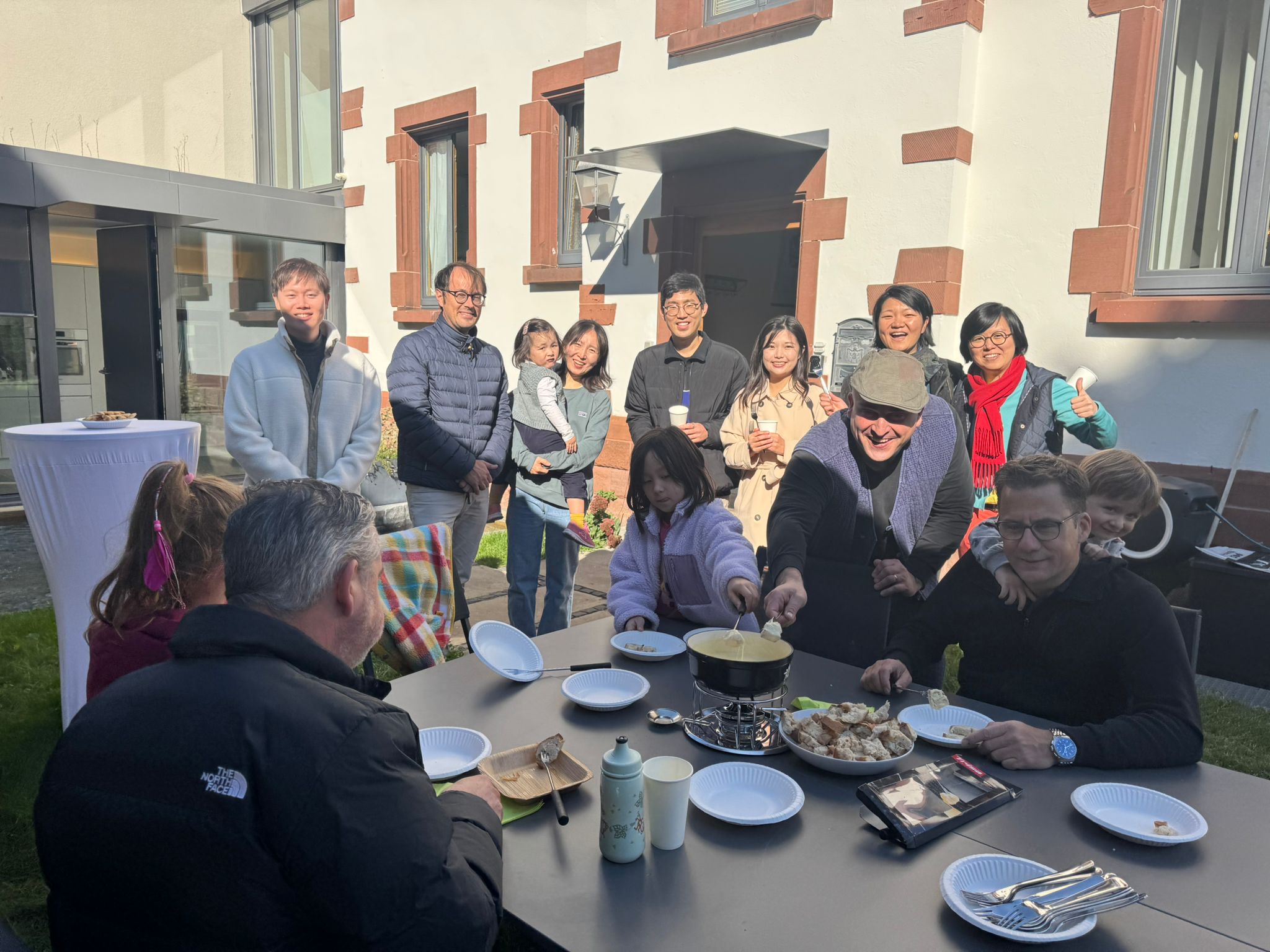 Swiss and Korean families gathered for communal fondue meal
