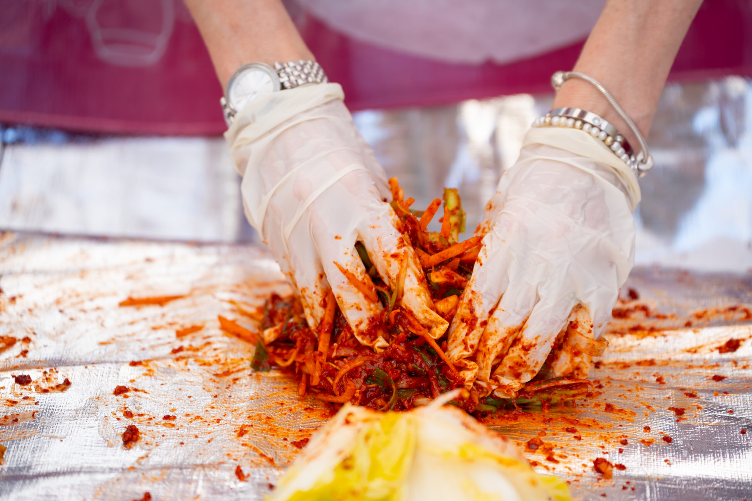 hands making kimchi