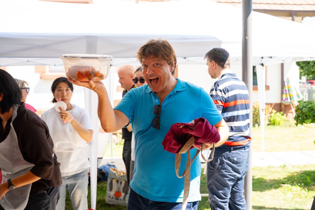 man holding kimchi proudly