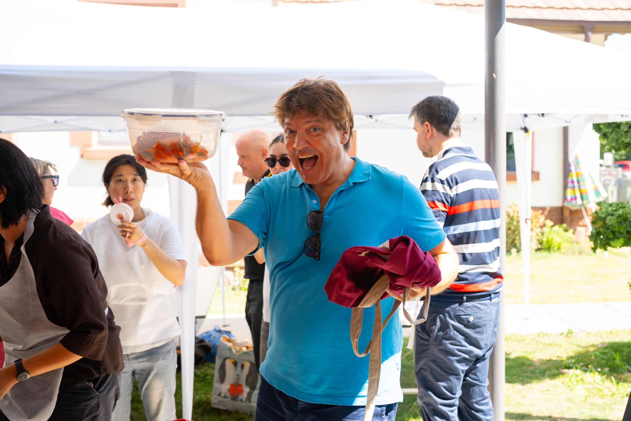 man holding kimchi proudly